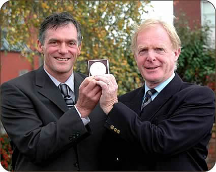 Peter Hetherington, left, receives the Blamire Medal awarded earlier this year to his father John from chairman of the Blamire trustees Michael Cowen.