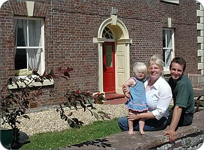 Julie and Martin Gaitskell with daughter Freya outside the farmhouse.