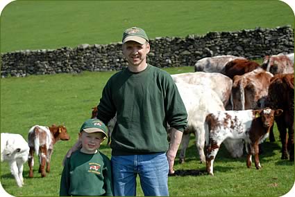 Tony Wood and his four year old son Jake with pure Beef Shorthorn cows and five to six week old calves at Abbots Reading.