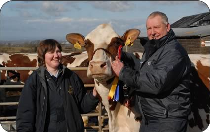 Christine and David with show cow Middle Emerald Mr which won the Ayrshire championship at the National All Breeds Show